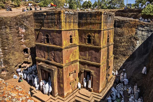 Lalibela, Ethiopia - Jan 06, 2023: Pilgrims gathered for Christmas church services (according to the the Ethiopian calendar ) at the Rock-Hewn Church of Saint George (Biete Ghiorgis), the best known of the the eleven monolithic churches of Lalibela .