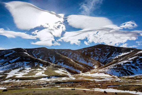 Snowy High Atlas Mountains with beautiful clouds, Morocco.